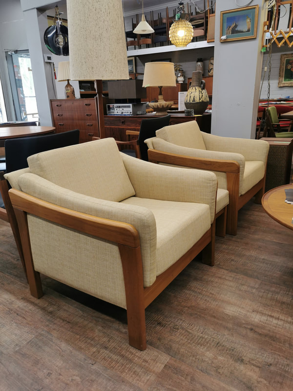 Teak living room arm chairs with upholstered sides. 